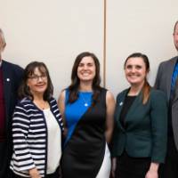 group of alum pose for picture